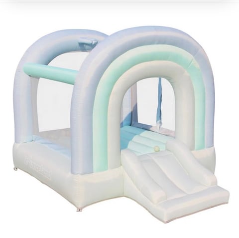 Pastel-colored inflatable bounce house with white base, mint and blue accents, entrance ramp, and interior arches